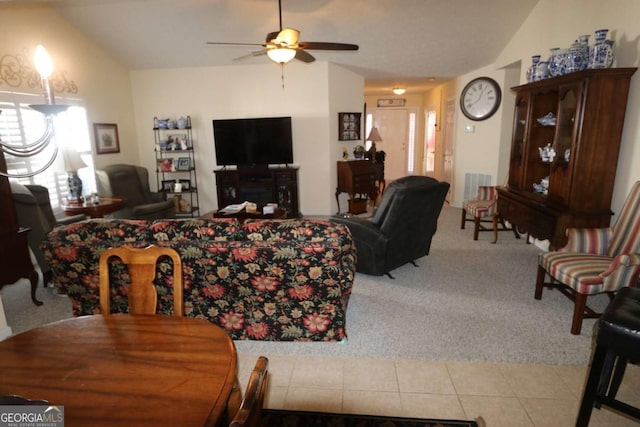 living room featuring lofted ceiling, light tile patterned flooring, a ceiling fan, and light colored carpet