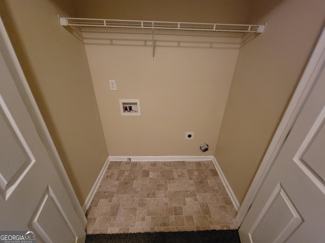 clothes washing area with hookup for a washing machine, stone finish floor, hookup for an electric dryer, laundry area, and baseboards