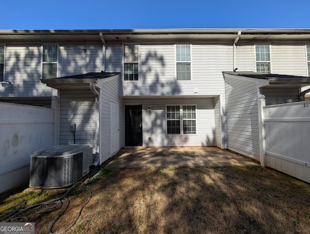 rear view of house with a patio area, central AC, and fence