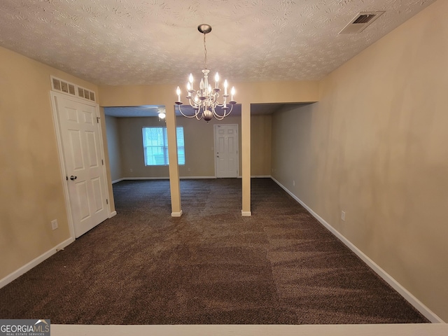 unfurnished dining area with dark colored carpet, visible vents, and baseboards