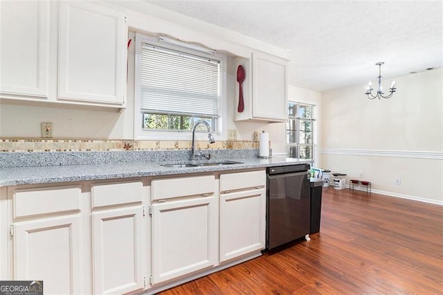 kitchen featuring a textured ceiling, wood finished floors, a sink, white cabinetry, and dishwasher