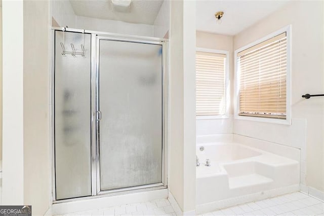 full bathroom with tile patterned flooring, a shower stall, baseboards, and a bath