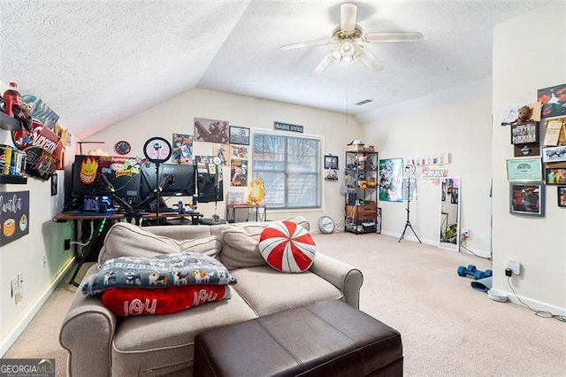 interior space with lofted ceiling, carpet, a textured ceiling, and a ceiling fan