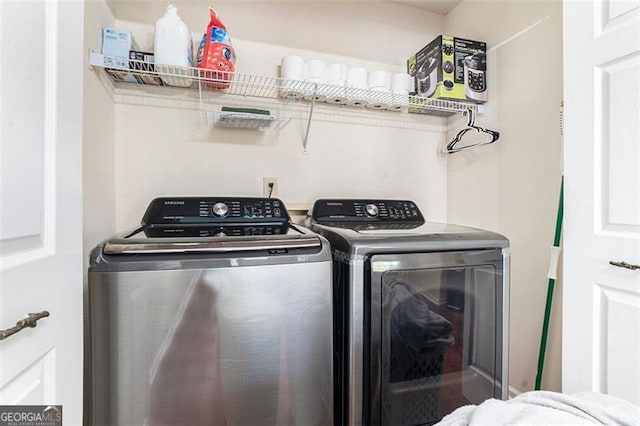 laundry room with laundry area and washing machine and clothes dryer