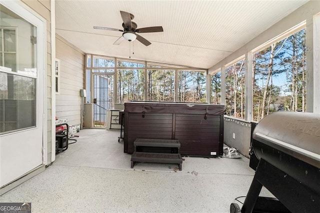 sunroom / solarium featuring a ceiling fan, a healthy amount of sunlight, and vaulted ceiling