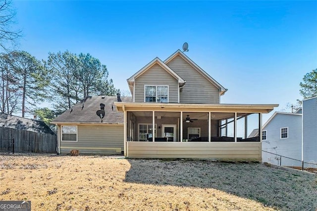 rear view of property with fence and a sunroom