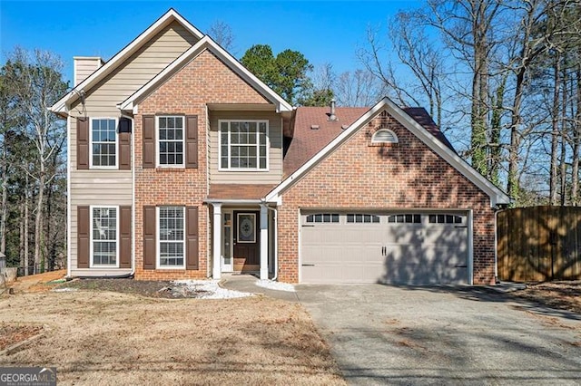 view of front of property with an attached garage, brick siding, fence, driveway, and a chimney