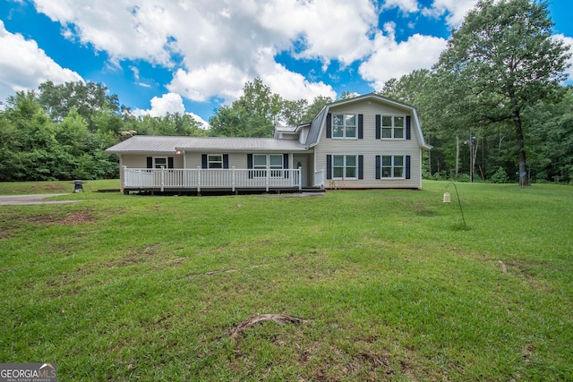 view of front of house featuring a front lawn, a deck, and a gambrel roof