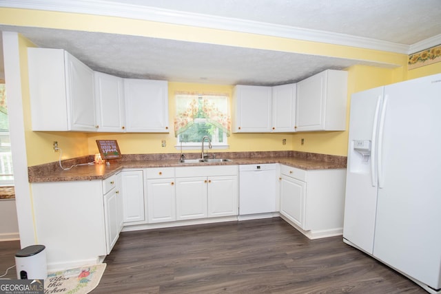 kitchen featuring white appliances, a sink, white cabinetry, dark wood finished floors, and crown molding