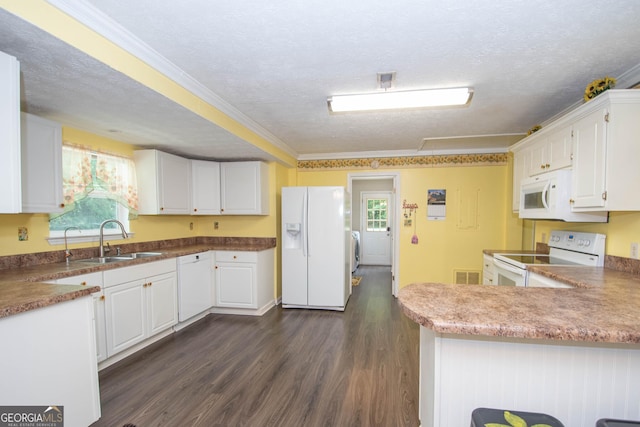 kitchen featuring white appliances, a sink, visible vents, white cabinetry, and washing machine and clothes dryer