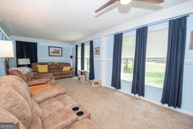 living room with carpet floors, crown molding, a textured ceiling, and ceiling fan