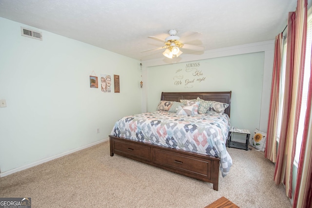 bedroom featuring light colored carpet, visible vents, ceiling fan, and baseboards