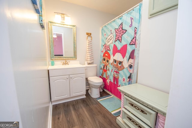 full bath featuring toilet, wood finished floors, and vanity