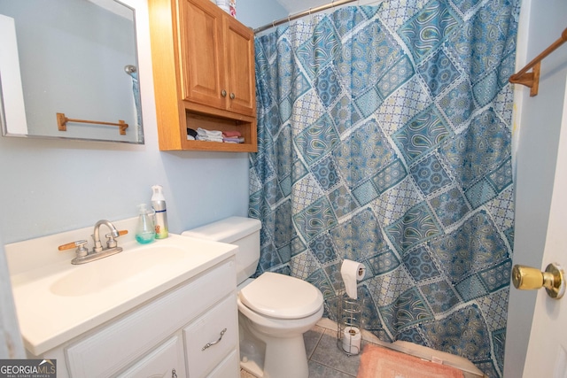 bathroom with vanity, toilet, and tile patterned floors