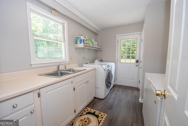 washroom featuring dark wood-type flooring, independent washer and dryer, cabinet space, and a sink