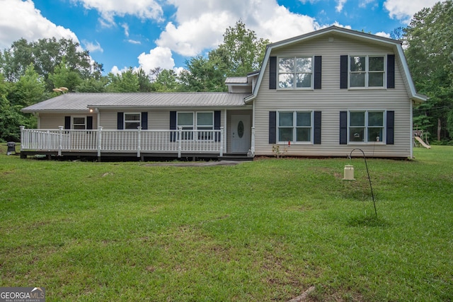 view of front of home featuring a front yard, metal roof, and a gambrel roof