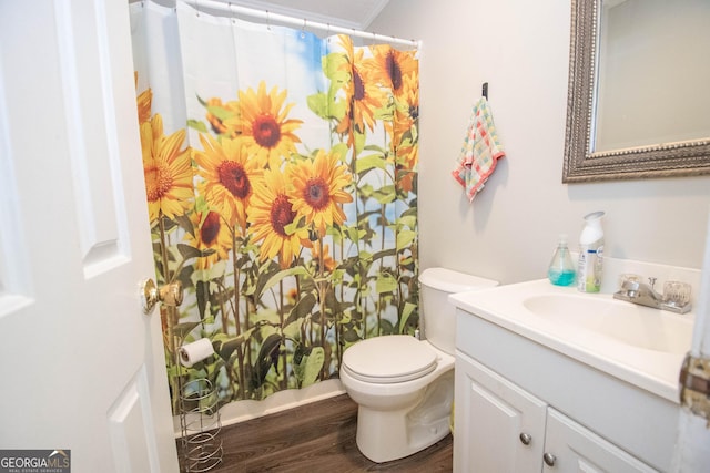 full bathroom with toilet, a shower with curtain, wood finished floors, and vanity