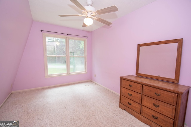 unfurnished bedroom with light carpet, a ceiling fan, and baseboards