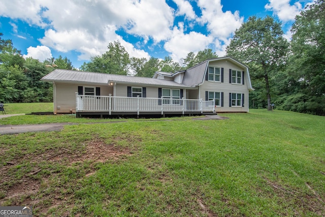 view of front of home featuring a deck, a front yard, metal roof, and a gambrel roof