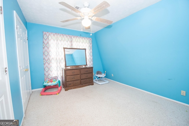 carpeted bedroom featuring ceiling fan and baseboards