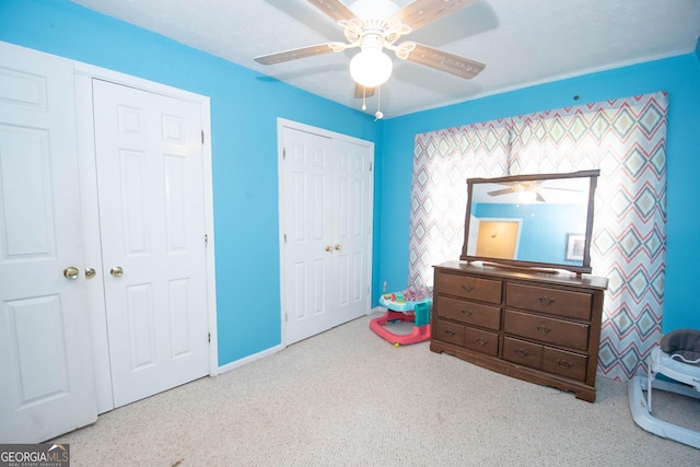 bedroom with ceiling fan and baseboards