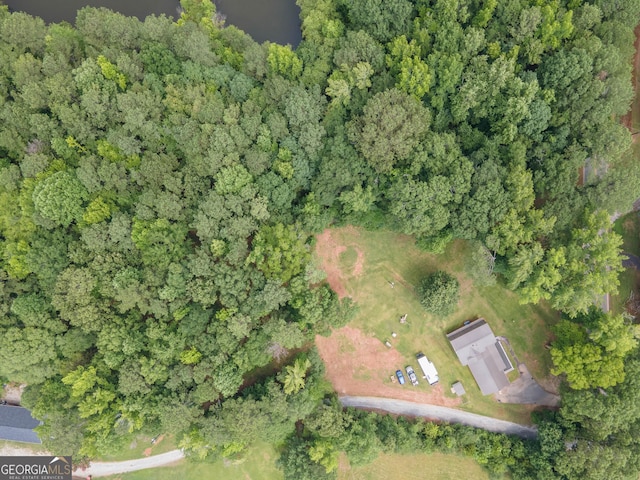 drone / aerial view featuring a wooded view