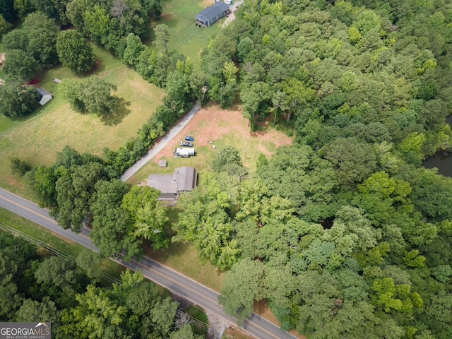 drone / aerial view featuring a wooded view