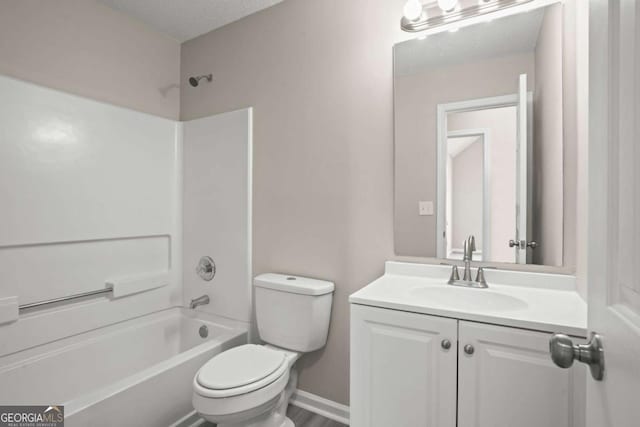 full bathroom featuring a textured ceiling, toilet, bathing tub / shower combination, vanity, and baseboards