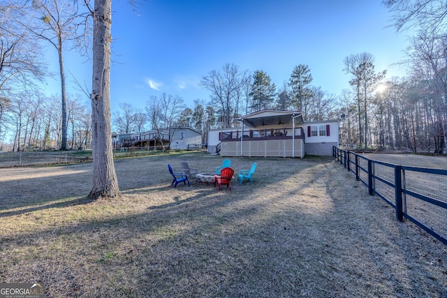 view of yard featuring a fire pit and fence