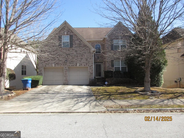 traditional-style home featuring brick siding, driveway, and a garage