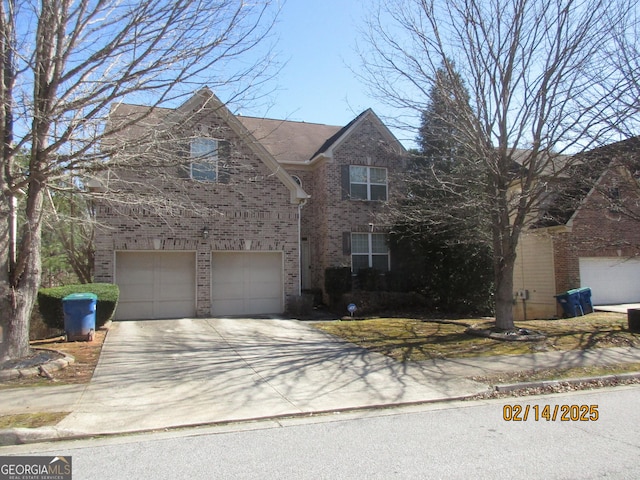 traditional-style home featuring brick siding, driveway, and an attached garage