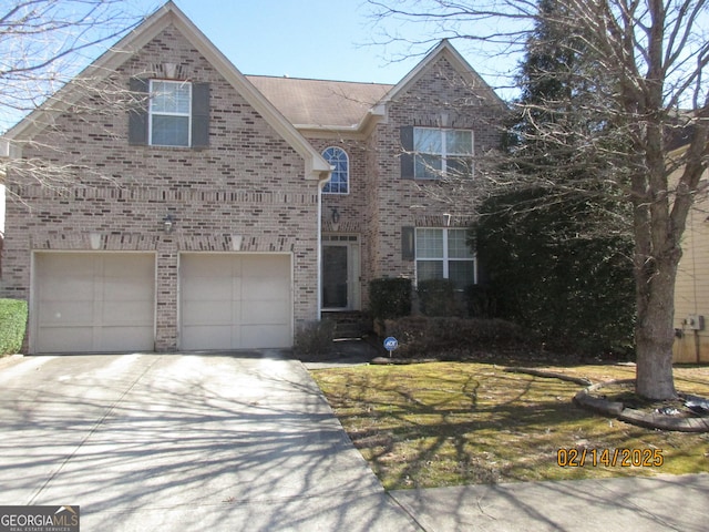 traditional-style home with brick siding and concrete driveway