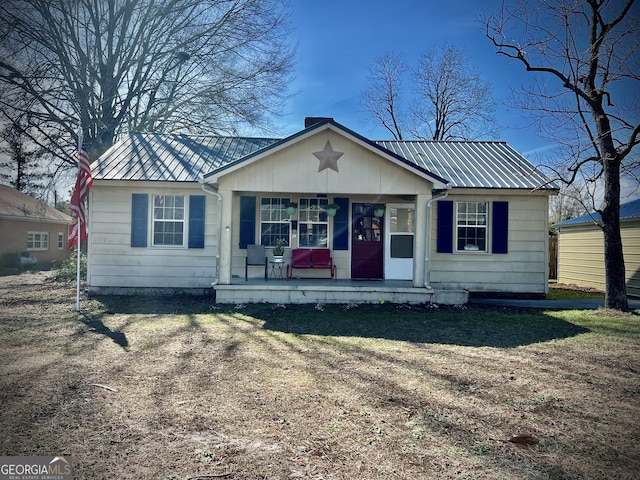 bungalow-style house featuring a porch and metal roof