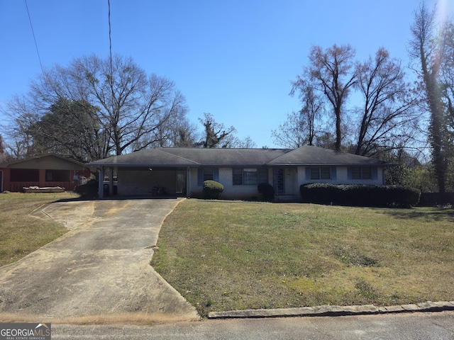 ranch-style house featuring driveway, an attached carport, and a front yard