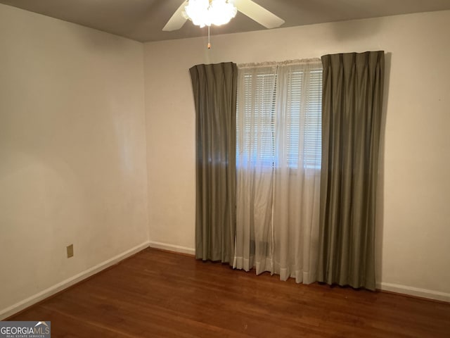 spare room with ceiling fan, baseboards, and wood finished floors