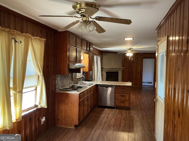 kitchen with dark wood-style floors, a peninsula, stainless steel dishwasher, and brown cabinetry