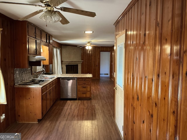 kitchen featuring a peninsula, a sink, dark wood-style floors, dishwasher, and brown cabinetry