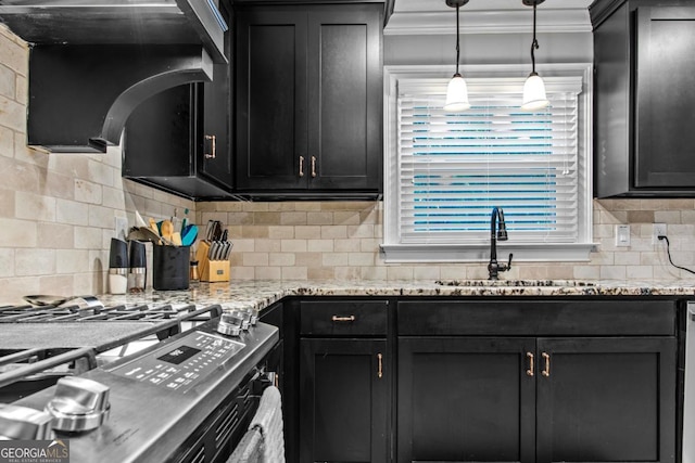 kitchen featuring tasteful backsplash, ornamental molding, a sink, gas range, and exhaust hood