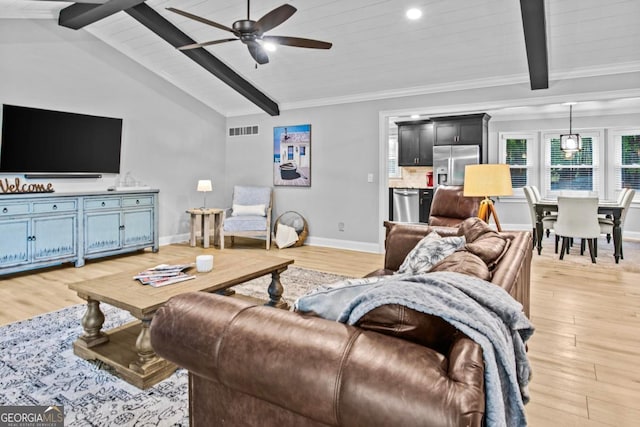 living room with vaulted ceiling with beams, a ceiling fan, visible vents, baseboards, and light wood finished floors