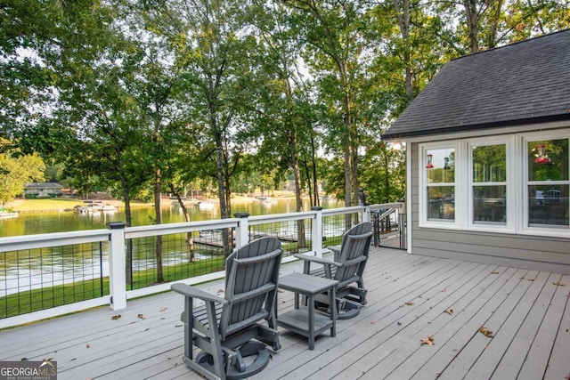 wooden terrace featuring a water view