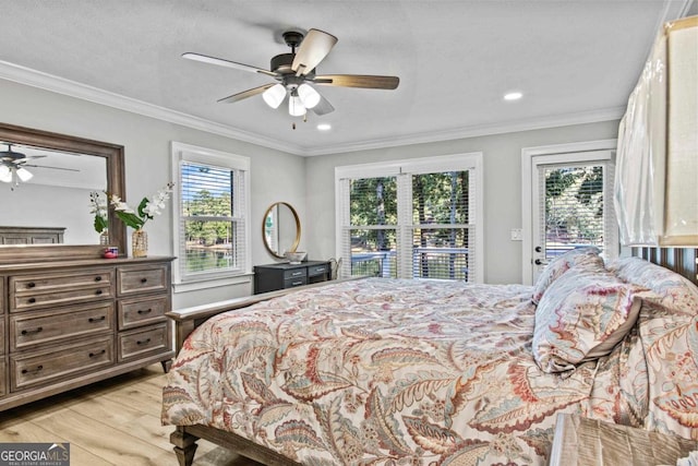 bedroom featuring multiple windows, crown molding, and light wood-style flooring