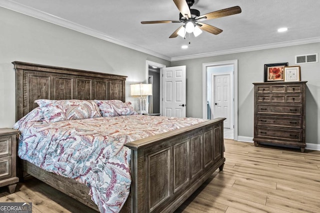 bedroom with visible vents, baseboards, light wood-style flooring, ornamental molding, and recessed lighting