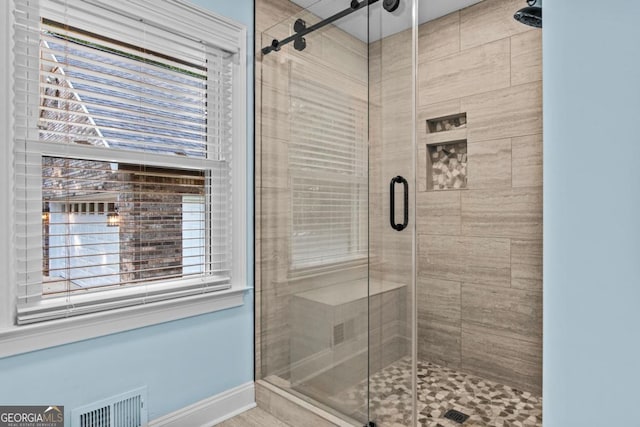 full bath with visible vents and a shower stall