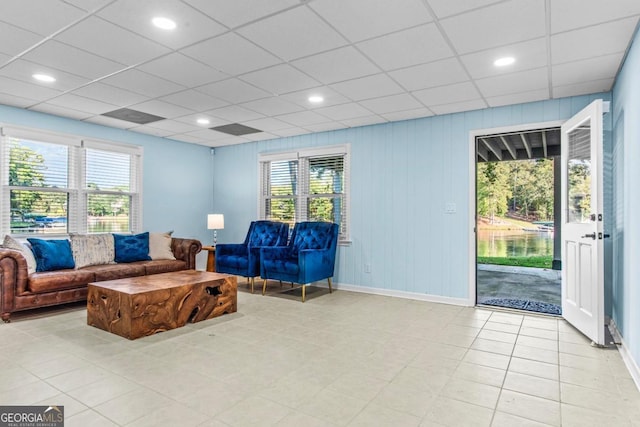 living room with a paneled ceiling, baseboards, and recessed lighting