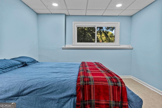 bedroom with recessed lighting, a drop ceiling, and baseboards