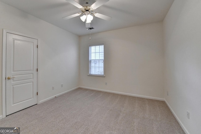 unfurnished room featuring light carpet, visible vents, baseboards, and ceiling fan