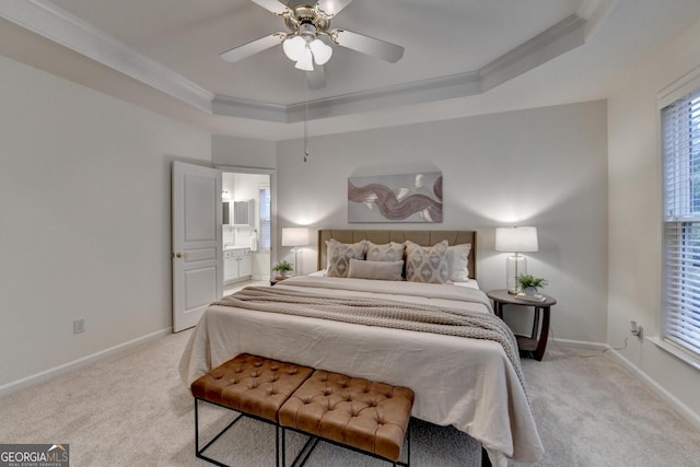 bedroom with a raised ceiling, light colored carpet, crown molding, and baseboards