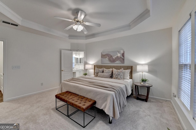 bedroom featuring a tray ceiling, visible vents, ornamental molding, carpet flooring, and baseboards