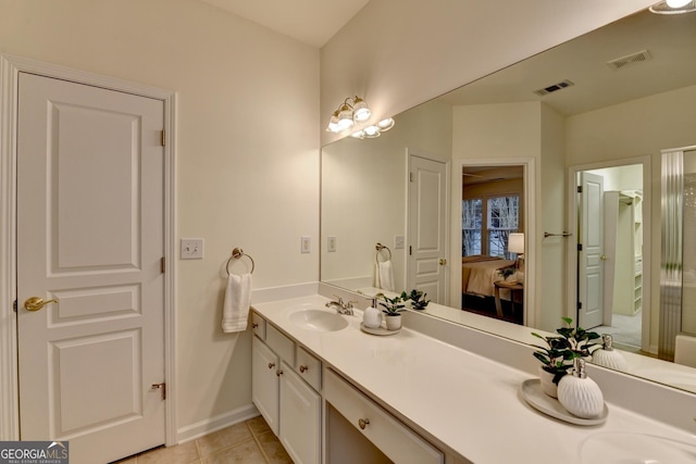 ensuite bathroom with visible vents, connected bathroom, a sink, and double vanity