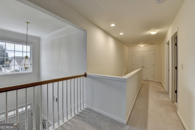 hallway featuring recessed lighting, baseboards, light carpet, and an upstairs landing